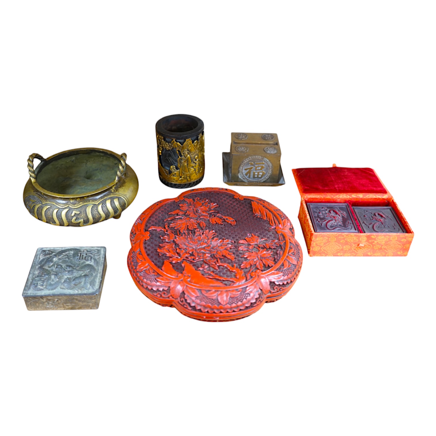 A collection of Chinese and Japanese items to include a lacquered box, a bronze tripod censer, a white metal box and carved seals, largest 25cm wide. Condition - mostly fair